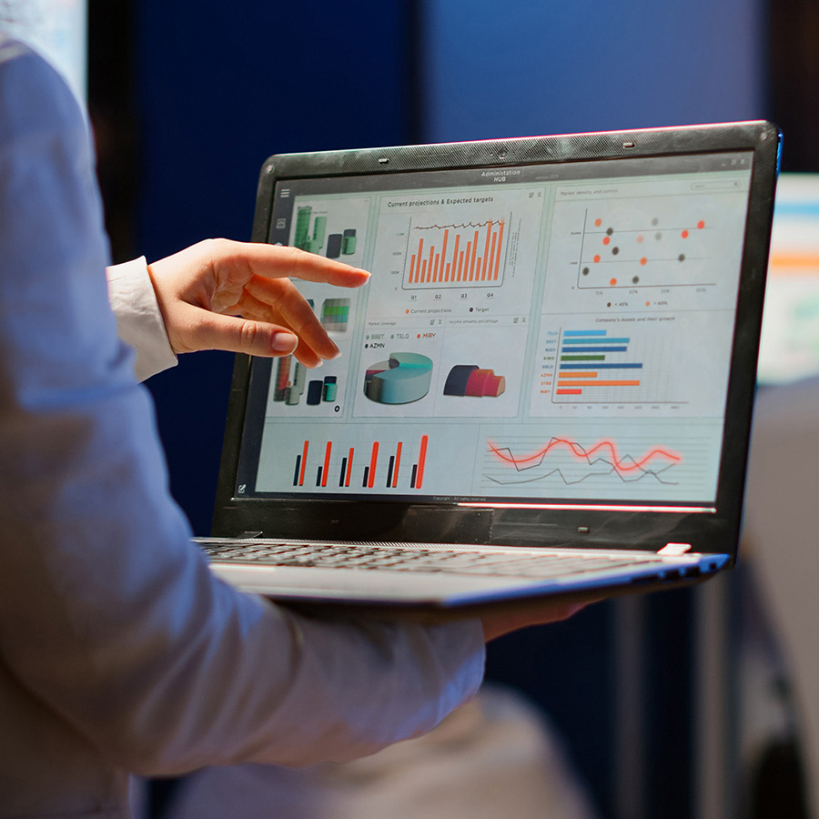 woman holding a laptop showing a well organized data dashboard depicting good data management practices.